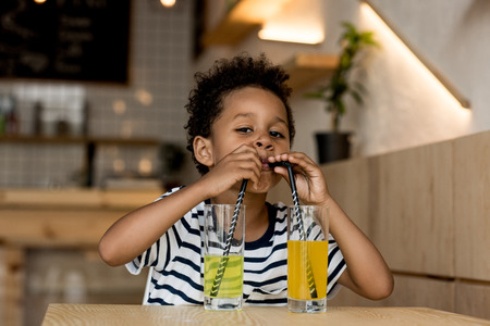 african american child drinking juiceの写真素材