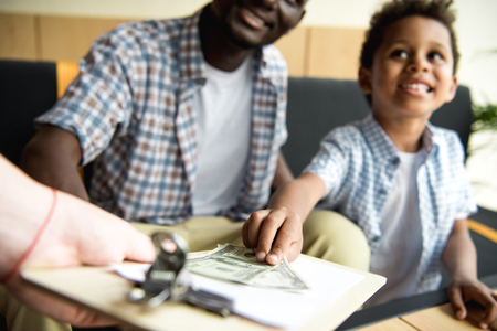 father and son paying billの写真素材