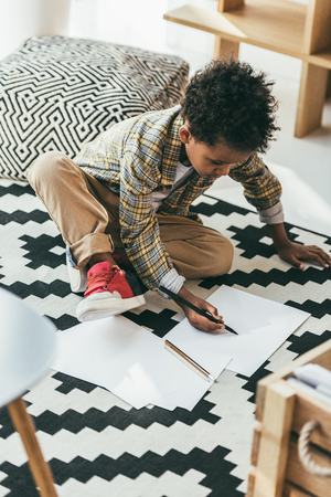 african american child drawing on floorの写真素材