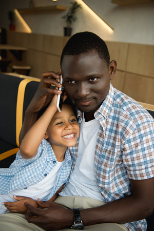 african american father and son with smartphoneの写真素材