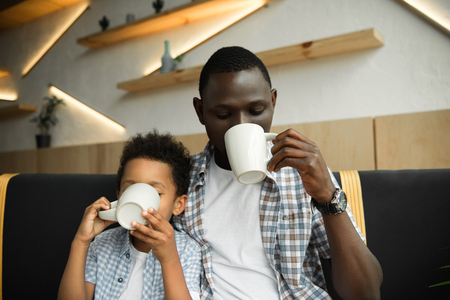 father and son drinking teaの写真素材