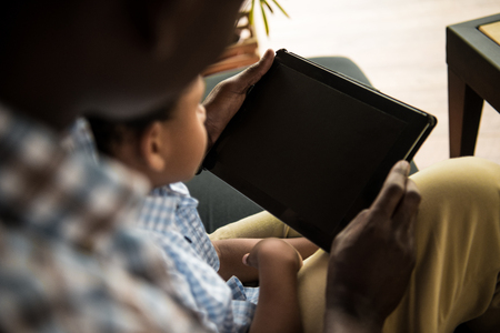 father and son with digital tabletの写真素材