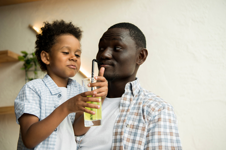 father and son drinking lemonadeの写真素材