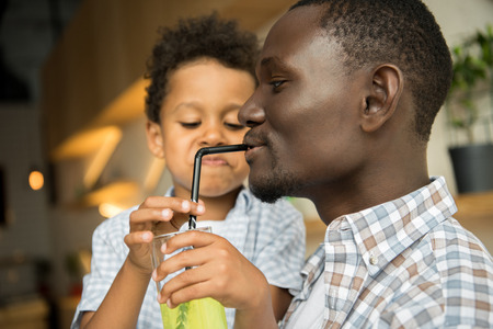 father and son drinking lemonadeの写真素材