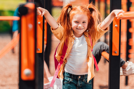 redhead child on playgroundの写真素材