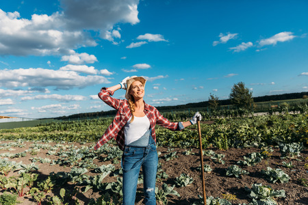 farmer with hoe working in fieldの写真素材