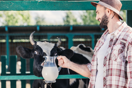 farmer with fresh milk in stallの写真素材