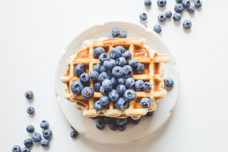 top view of plate of tasty stacked waffles with blueberriesの写真素材