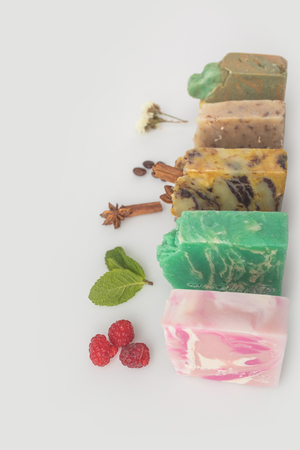close-up shot of homemade soap with various ingredients on white surfaceの写真素材