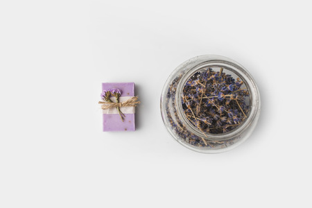 top view of handcrafted lavender soap with jar of flowers on white surfaceの写真素材