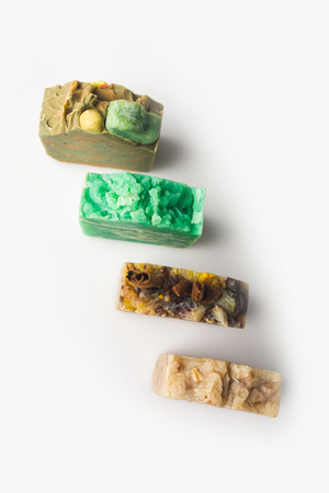 close-up shot of various natural homemade soap bars on white surfaceの写真素材
