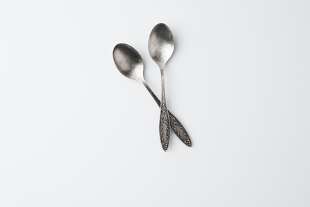 top view of crossed spoons isolated on whiteの写真素材