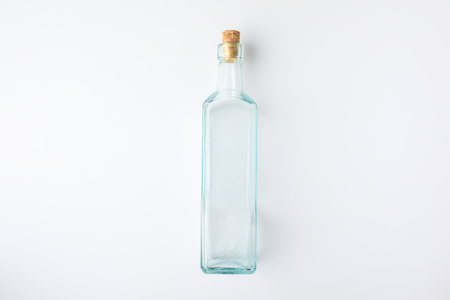 Top view of transparent glass bottle with plug isolated on whiteの写真素材