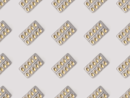 Set of blister packs with yellow pills isolated on white