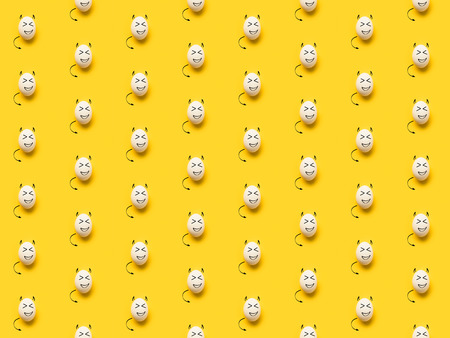 Set of painted eggs with devils isolated on yellow の写真素材