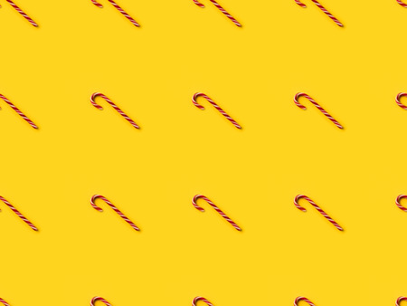 Set of candy canes isolated on yellowの写真素材
