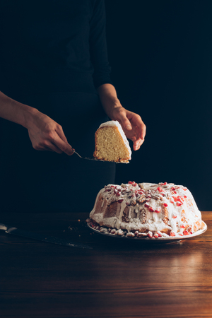 cropped view of woman holding piece of traditional christmas cakeの写真素材
