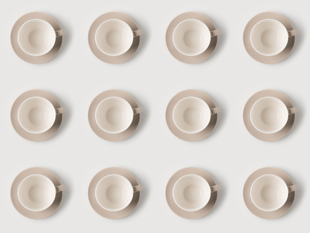 top view of pattern of empty coffee cups on white surfaceの写真素材