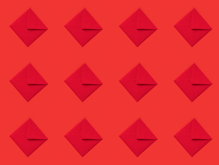 top view of pattern made from festive red envelopes isolated on redの写真素材