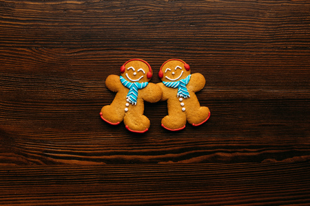 top view of Gingerbread men cookies on wooden tabletop  