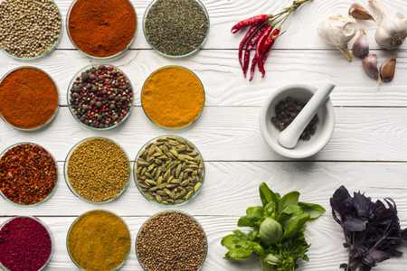 Top view of bowls with spices and mortar with pestleの写真素材