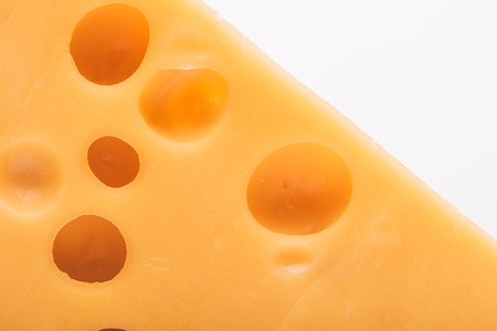 close up view of tasty cheddar cheese isolated on white