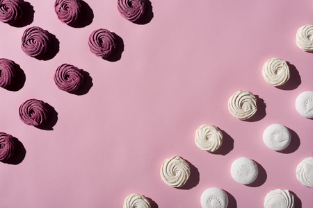 berry and white marshmallows on pink surface with copy spaceの写真素材