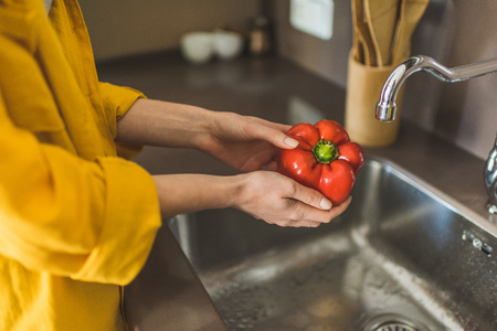 Woman Washing Red Pepperの写真素材
