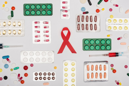 aids ribbon with pills and syringesの写真素材
