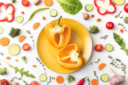 cut yellow bell pepper on plateの写真素材