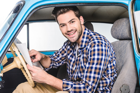 man sitting in car with mapの写真素材