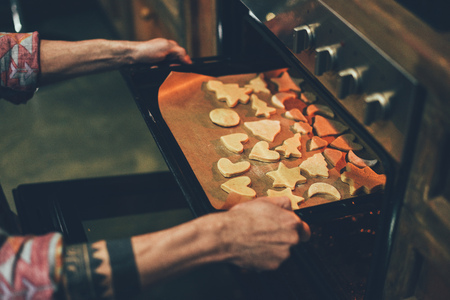 person baking christmas cookies
