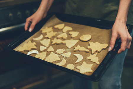 person baking christmas cookies