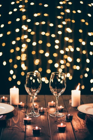 wineglasses on table with candlesの写真素材