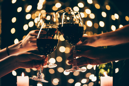 people clinking glasses with wineの写真素材