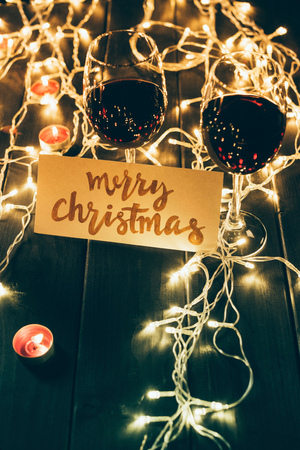 Wineglasses and merry christmas cardの写真素材