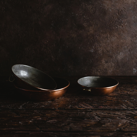 arranged empty vintage utensils on rustic wooden tableの写真素材
