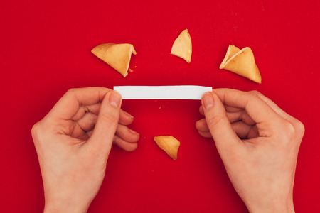 woman opening traditional fortune cookie, Chinese New Year conceptの写真素材