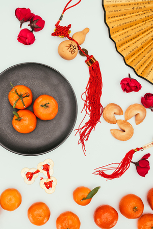 chinese fortune cookies with tangerines and traditional talismans isolated on white, Chinese New Year conceptの写真素材