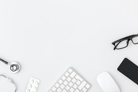 keyboard surrounded by glasses, computer mouse, stethoscopeの写真素材