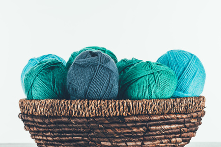 warm yarn balls in wicker basketの写真素材