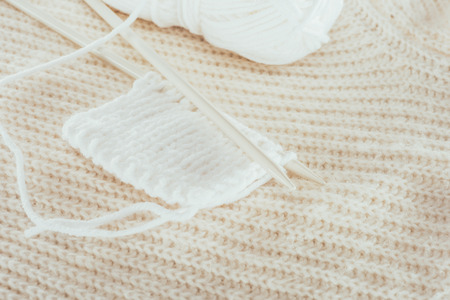 knitting needles with white woolen yarnの写真素材