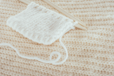 knitting needles with white woolen yarnの写真素材