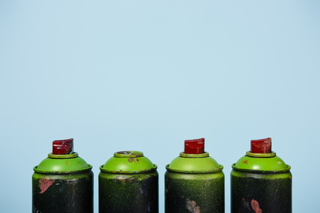 arranged cans with aerosol paint isolated on blueの写真素材