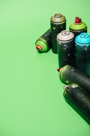 arranged cans with aerosol paint isolated on greenの写真素材