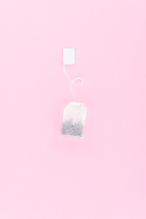 one tea bag isolated on pinkの写真素材