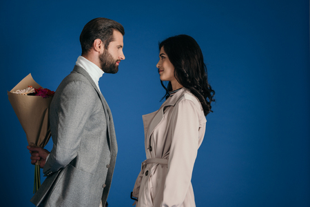 boyfriend hiding bouquet from girlfriendの写真素材