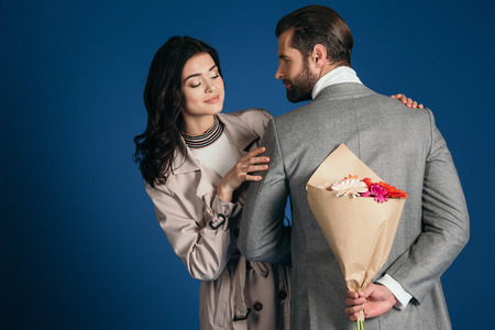 boyfriend hiding bouquet from girlfriendの写真素材