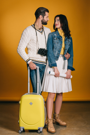happy couple of tourists with travel bagの写真素材