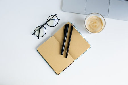 top view of laptop, notepad, eyeglasses and glass of coffee,の写真素材